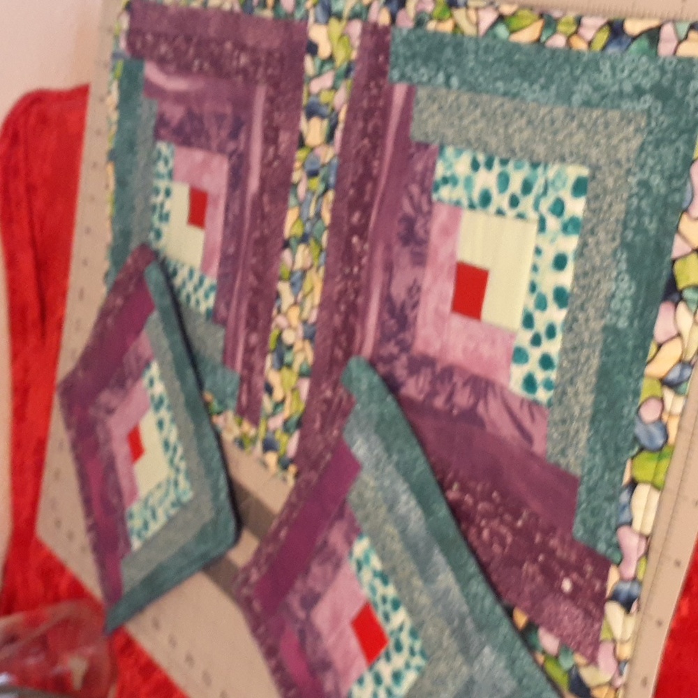 Three piece hot pads, handmade. Log Cabin design with vibrant fabrics.